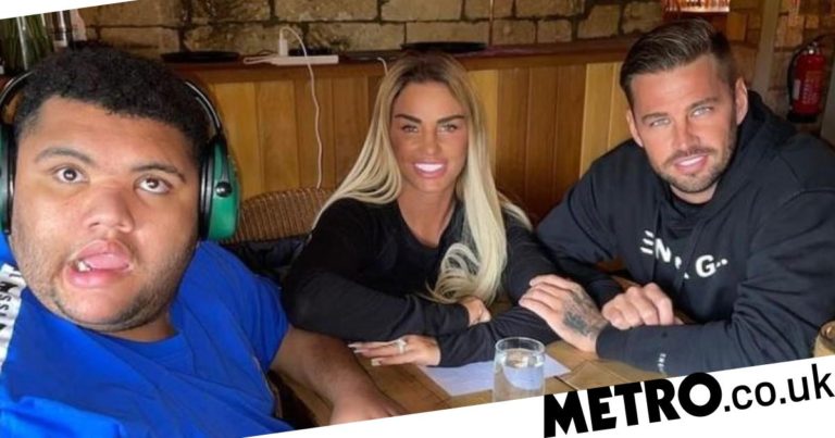 Katie Price all smiles as in family photo with Harvey and Carl Woods