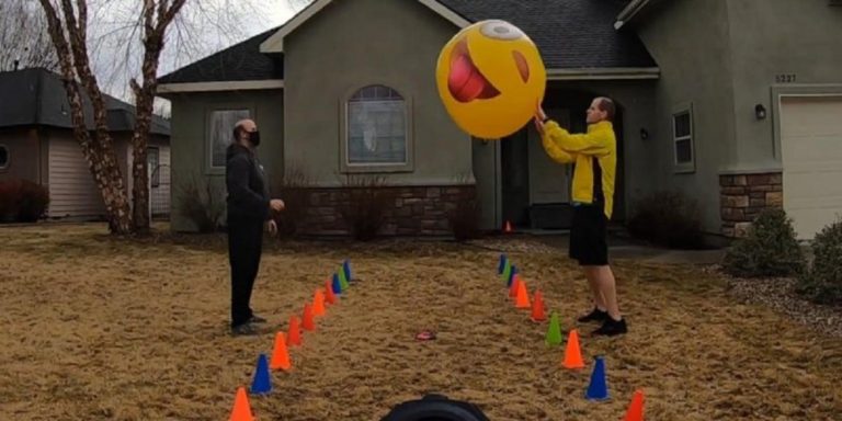 Men pass a huge beach ball 673 times