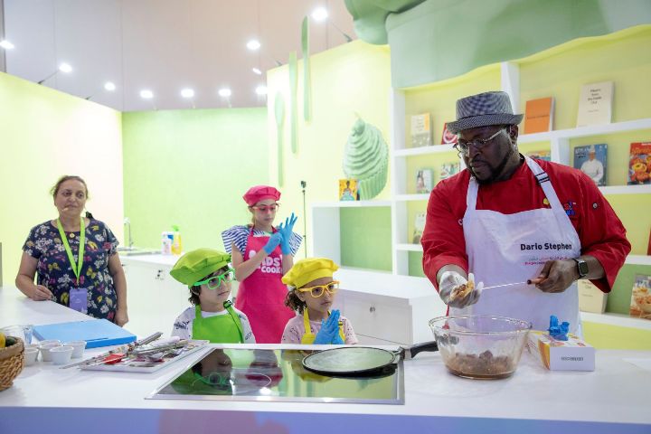 Children take charge of the kitchen during a live cooking demo at 13th Sharjah Children’s Reading Festival