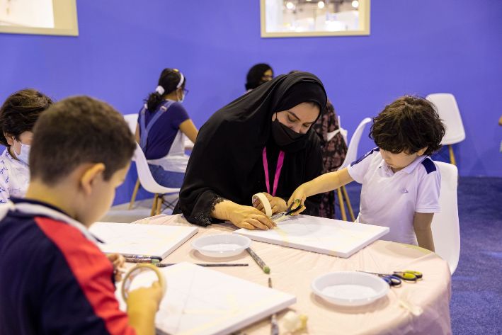 Children try their hand at Islamic tile painting at SCRF 2022