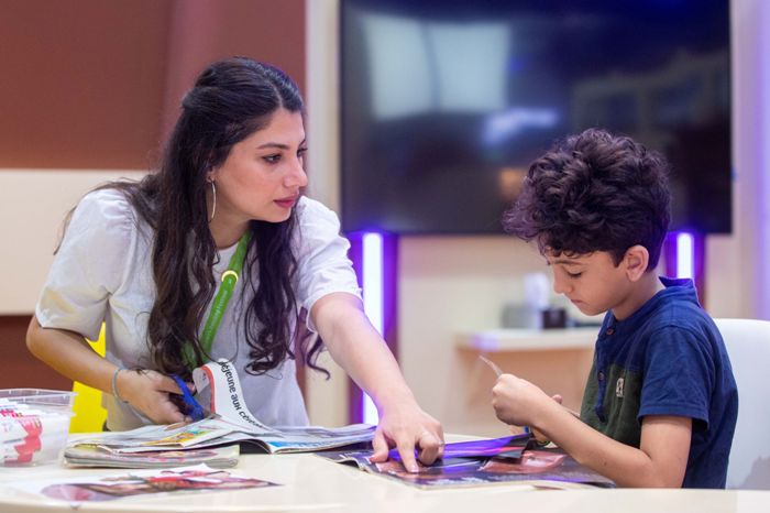 A collage art workshop at SCRF 2023 encourages young artists to cut and stick their way to new creations